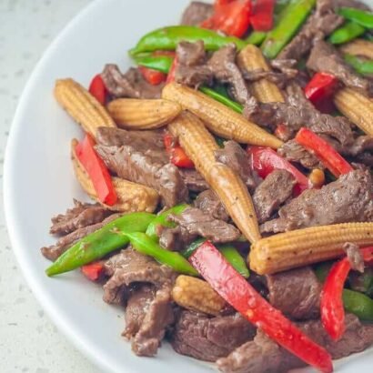 Beed Stir fry with baby corn snow peas and carrots